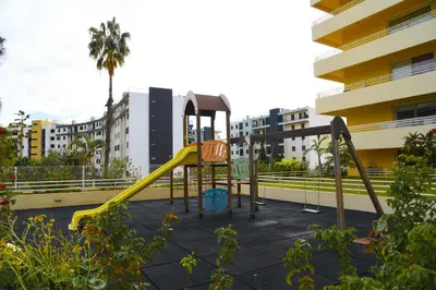 a playground with a slide in front of a building at Green Pearl Apartment in Funchal