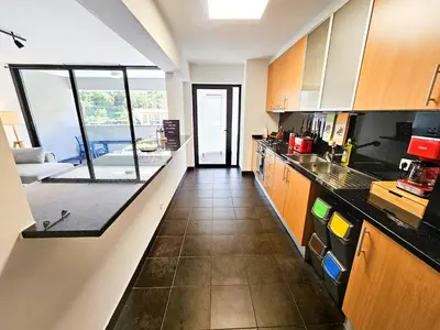 a kitchen with wooden cabinets and a counter top at Machico Oasis - Mountainview in Machico