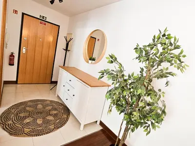 a bathroom with a sink and a mirror and a plant at Machico Oasis - Mountainview in Machico