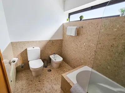 a bathroom with a toilet and a sink and a shower at Machico Oasis - Mountainview in Machico