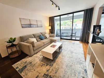 a living room with a couch and a table at Machico Oasis - Mountainview in Machico