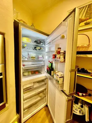 an open refrigerator with its door open and food inside at Quartos privados - Quinta da Paz in Santa Cruz