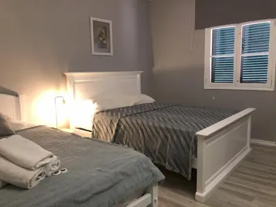 a bedroom with two beds and a window at Funchal 19 in Funchal