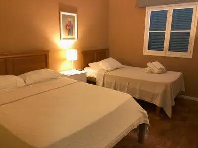 a hotel room with two beds and a window at Funchal 19 in Funchal