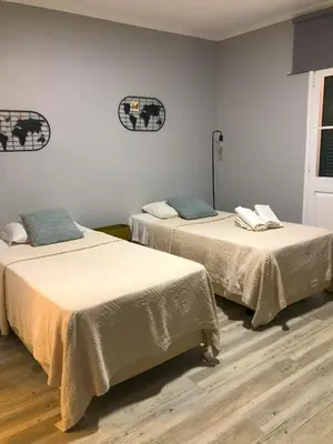 two beds sitting next to each other in a room at Funchal 19 in Funchal