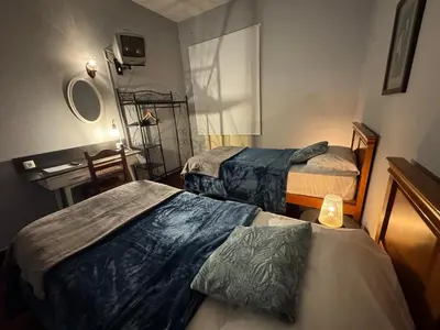 a hotel room with two beds and a sink at Funchal 19 in Funchal