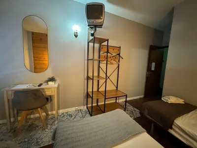 a room with a bed and a desk and a mirror at Funchal 19 in Funchal