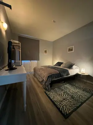 a bedroom with a bed and a desk with a television at Funchal 19 in Funchal