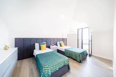 a room with two beds and a mirror at Pena View Apartment in Santa Cruz