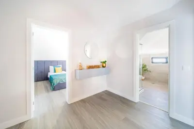 a white room with a bed and a mirror at Pena View Apartment in Santa Cruz