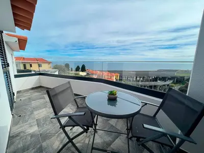a patio with a table and chairs on a balcony at Pena View Apartment in Santa Cruz