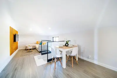 a white living room with a table and a couch at Pena View Apartment in Santa Cruz