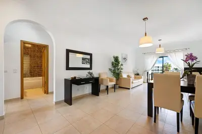 a living room with a table and a dining room at Chez Hélène et Paulo - Lagos in Lagos