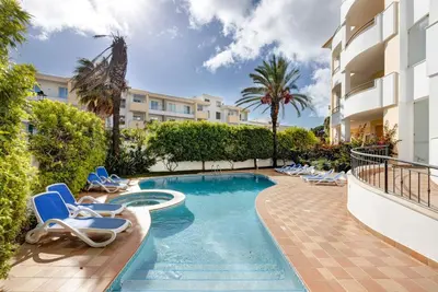 a swimming pool with lounge chairs and a resort at Chez Hélène et Paulo - Lagos in Lagos