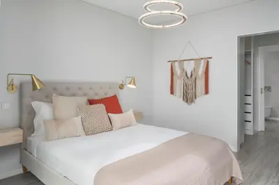 a bedroom with a large white bed with pillows at Vila Chu by An Island Apart in Ponta do Sol