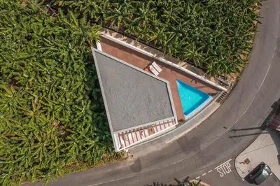 an overhead view of a swimming pool in the grass at Vila Chu by An Island Apart in Ponta do Sol