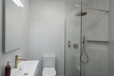 a bathroom with a shower and a toilet and a sink at Vila Chu by An Island Apart in Ponta do Sol