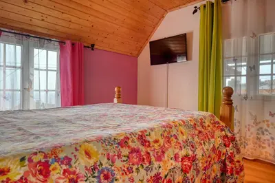 a bedroom with a bed with a colorful bedspread at Casa Primavera, a Home in Madeira in Ponta do Sol