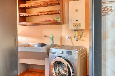 a laundry room with a washing machine and a sink at Casa Primavera, a Home in Madeira in Ponta do Sol