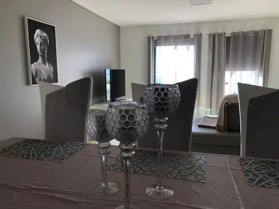 a dining room with a table with wine glasses on it at Forum Ocean View Apartment in Funchal