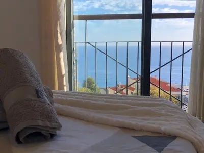 a hotel room with a bed and a view of the ocean at Forum Ocean View Apartment in Funchal