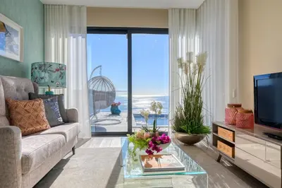 a living room with a couch and a tv at Quinta do Feliz, a Home in Madeira in Ponta do Sol
