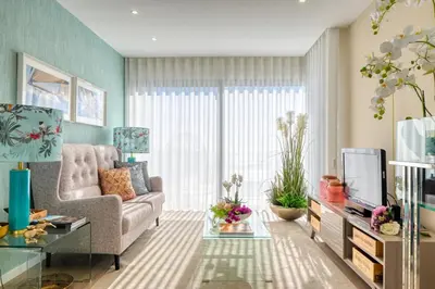 a living room with a couch and a tv at Quinta do Feliz, a Home in Madeira in Ponta do Sol