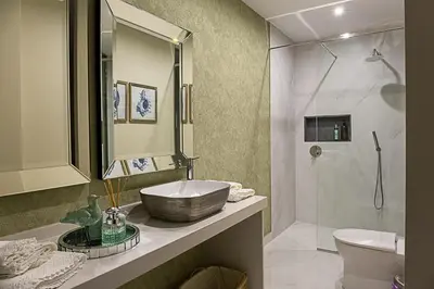 a bathroom with a sink and a toilet and a shower at Quinta do Feliz, a Home in Madeira in Ponta do Sol