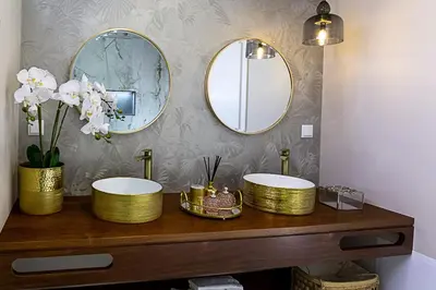 a bathroom with two sinks and two mirrors at Quinta do Feliz, a Home in Madeira in Ponta do Sol