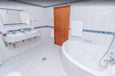 a bathroom with a tub and a toilet and a sink at 2 Bedroom Apartment in Calheta in Arco da Calheta