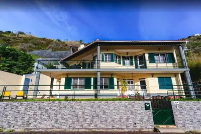 a large house on top of a hill at 2 Bedroom Apartment in Calheta in Arco da Calheta