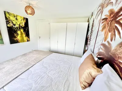 a bedroom with a bed with a poster of a giraffe at Mar a Vista by Your Madeira Rentals in Ponta do Sol