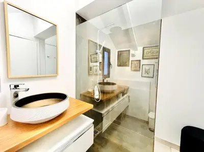 a bathroom with a large sink and a mirror at Mar a Vista by Your Madeira Rentals in Ponta do Sol