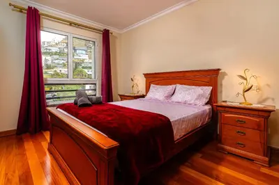 a bedroom with a large bed and a window at Katerina´s Place - Funchal in Funchal