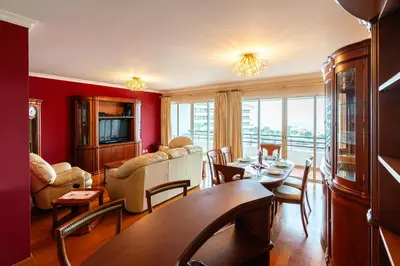a living room with red walls and a table and chairs at Katerina´s Place - Funchal in Funchal