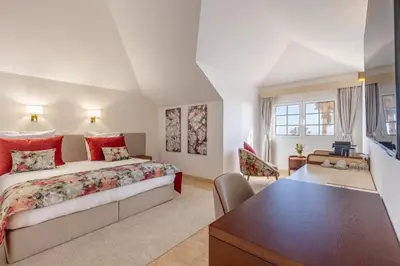 a large bedroom with a bed and a desk at Quinta Alegre in Calheta