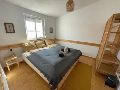 a bedroom with a bed with shoes on it at Algarve Surf House in Raposeira
