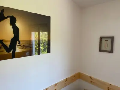 a bedroom with a bed with shoes on it at Algarve Surf House in Raposeira