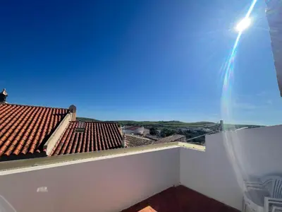 a view from the balcony of a house with a roof at Algarve Surf House in Raposeira