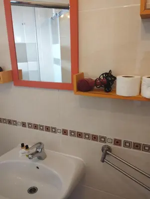 a bathroom with a sink and a mirror and towels at Casa Sarguito in Sagres