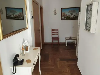 a living room with a white table and a chair at Casa Sarguito in Sagres
