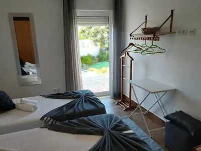 a bedroom with a bed and a desk and a window at Casa Sarguito in Sagres
