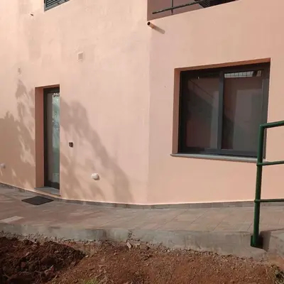 a building with two windows on the side of it at Casa Bela Vista Studio 2 in Ribeira Brava