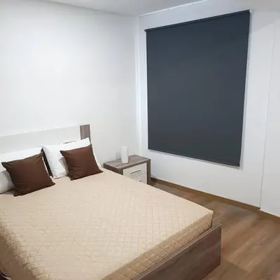 a bedroom with a bed with a large tv on the wall at Casa Bela Vista Studio 2 in Ribeira Brava