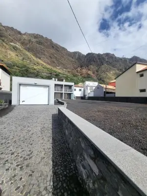 a house with a large white garage at Casa Marcelino Refugio Frente Mar in Paul do Mar