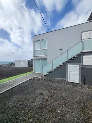 a house with a staircase on the side of it at Casa Marcelino Refugio Frente Mar in Paul do Mar