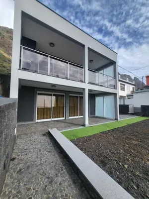 a modern house with large windows and a yard at Casa Marcelino Refugio Frente Mar in Paul do Mar