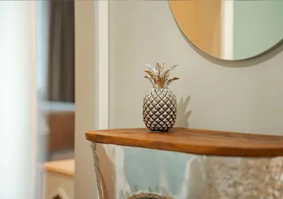 a pineapple sitting on a table in front of a mirror at Better Together Funchal I in Funchal