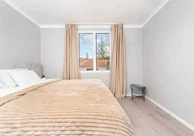 a bedroom with a large bed and a window at Better Together Funchal I in Funchal
