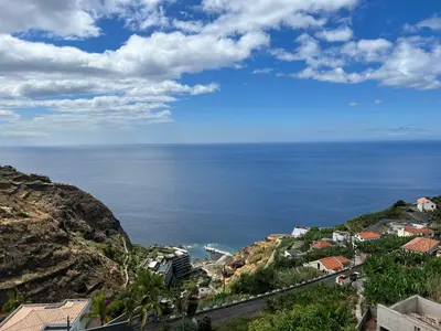 a view of the ocean from a mountain at Pana House in Calheta